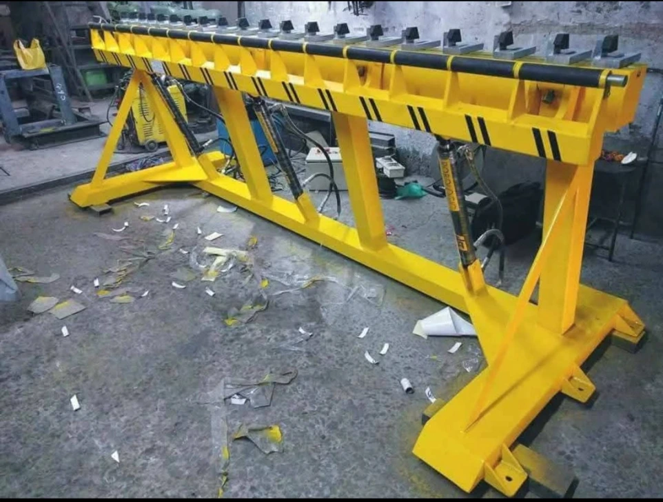 A heavy-duty hydraulic lifting and clamping beam engineered for holding, positioning, or lifting long components during fabrication or assembly. The structure is reinforced with welded steel supports, equipped with multiple hydraulic cylinders for uniform load distribution, and finished with high-visibility industrial coating for enhanced safety and durability.